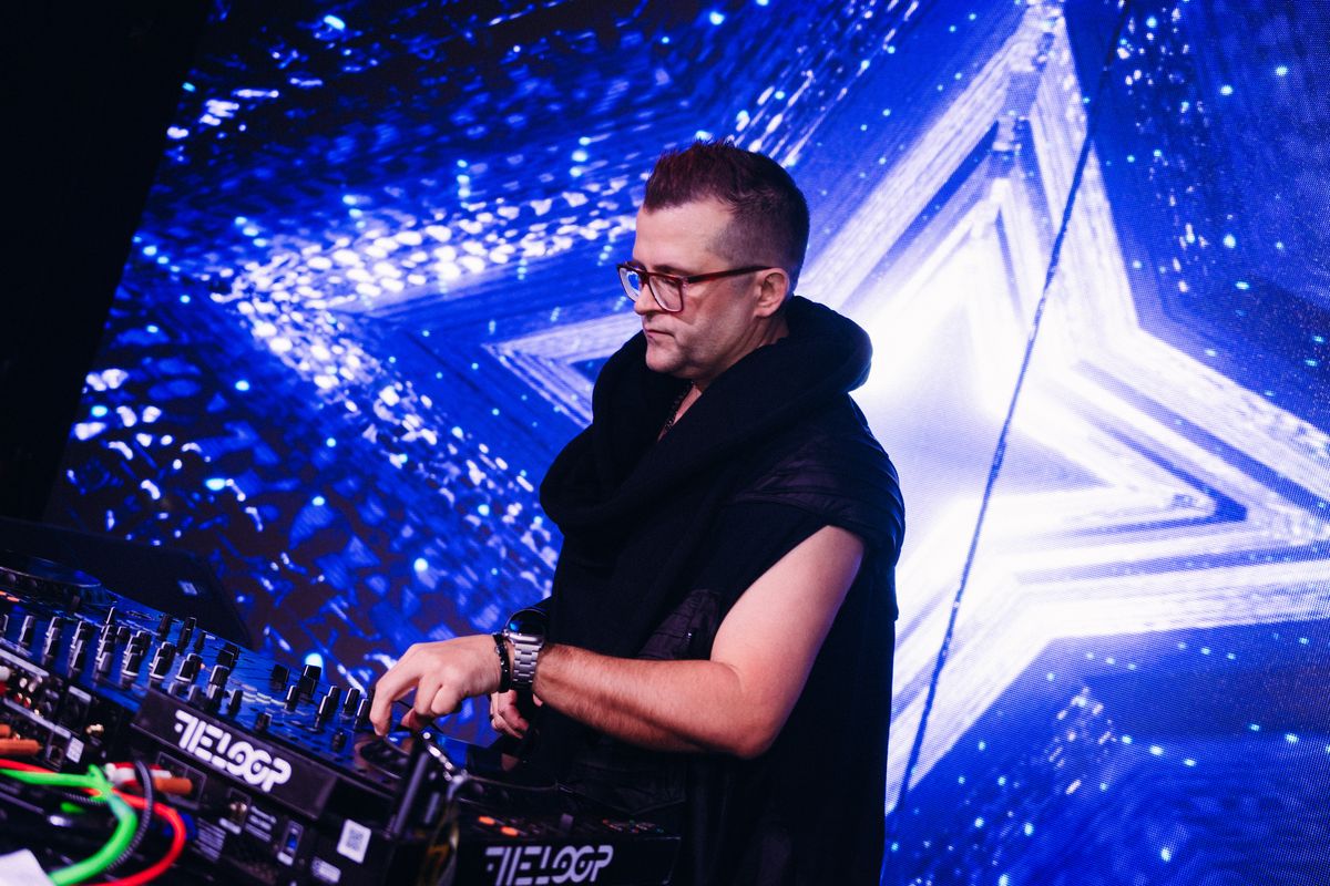 EL PADRE performing under blue lights